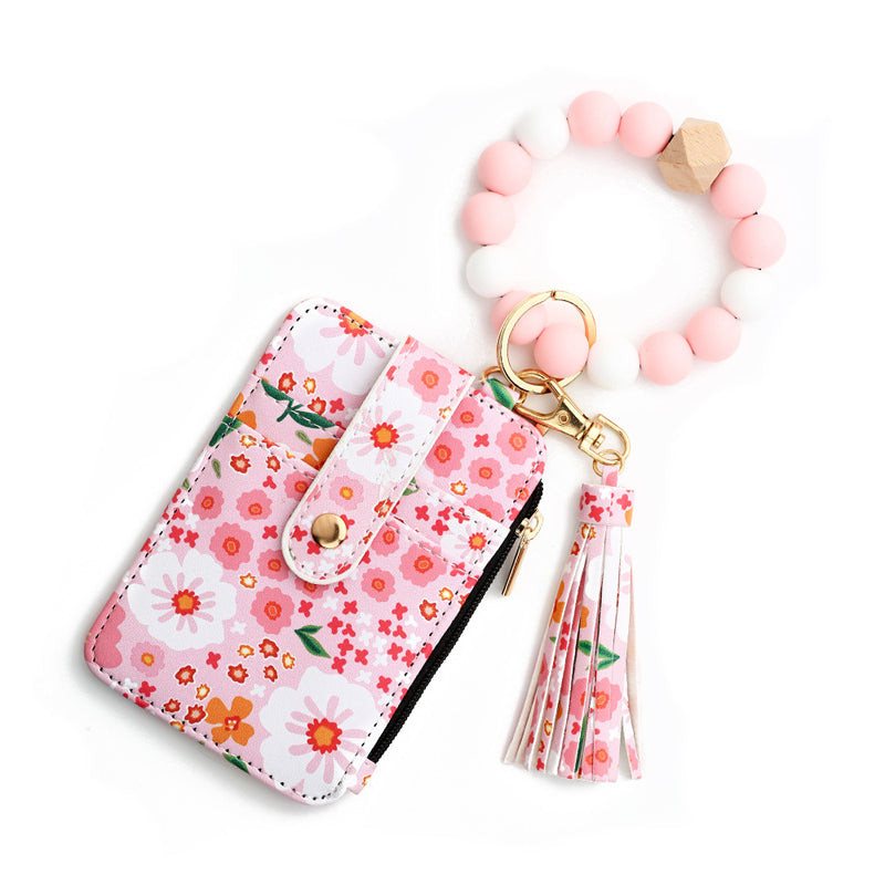 Liten plånbok i blommigt läder med nyckelring och armband