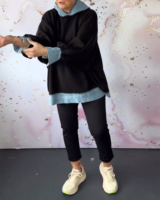 Avslappnad luvtröja på lyktaärm i kontrastfärg