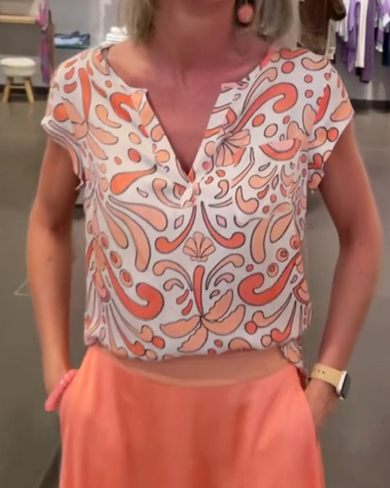 Printad ledig blus med V-ringning och raglanärmar