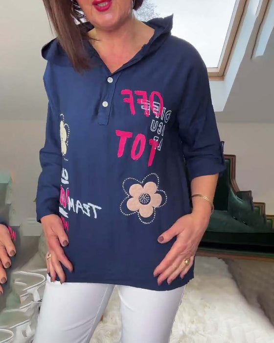 Avslappnad broderad långärmad huvtopp med blommiga bokstäver