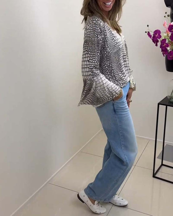 Blus med blommönster och snodd