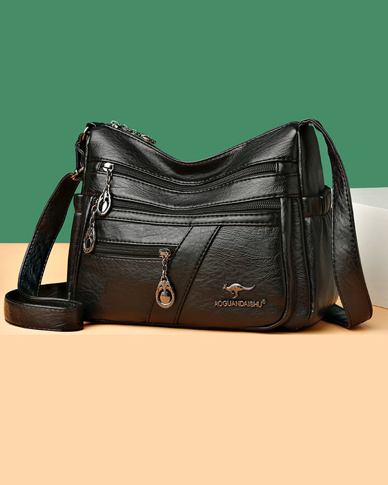 Korsväska i mjukt läder med flera fickor