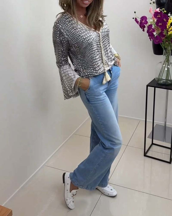 Blus med blommönster och snodd