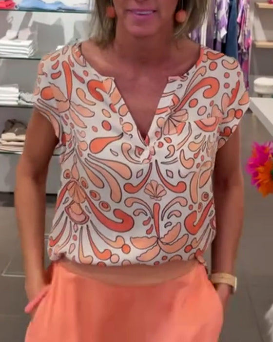 Printad ledig blus med V-ringning och raglanärmar