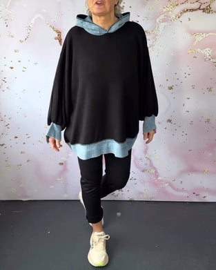 Avslappnad luvtröja på lyktaärm i kontrastfärg