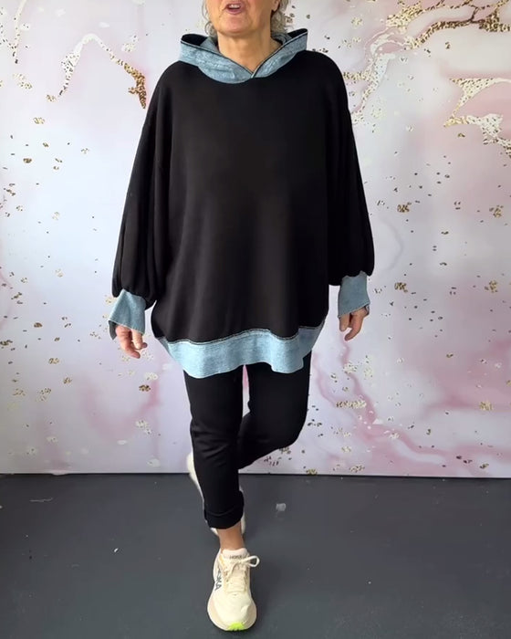 Avslappnad luvtröja på lyktaärm i kontrastfärg