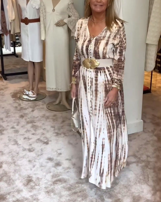 Tryckt långärmad klänning med V-ringad slits i midjan