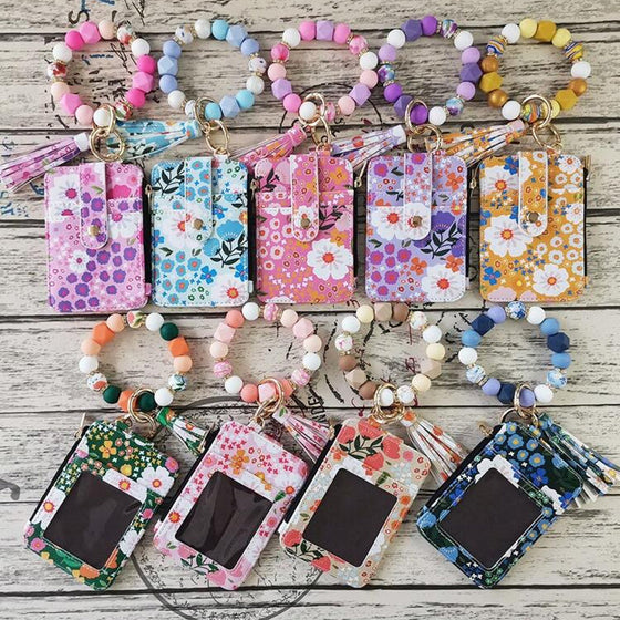 Liten plånbok i blommigt läder med nyckelring och armband