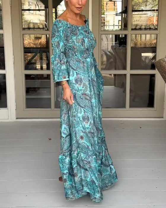 Elegant långklänning med tryck med en axel och utsvängningsärm