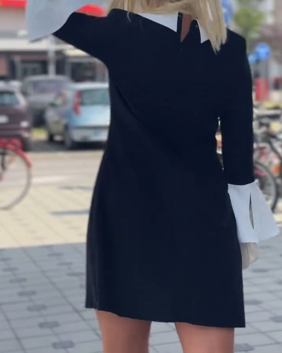 Elegant klänning med klockärm i kontrast