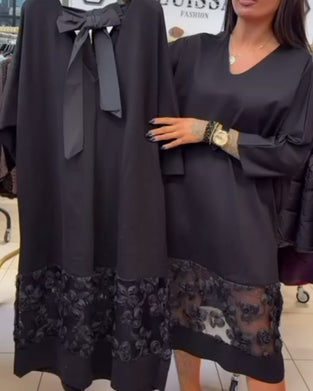 Stilfull Klänning Med Rosett På Ryggen Och V-Ringning