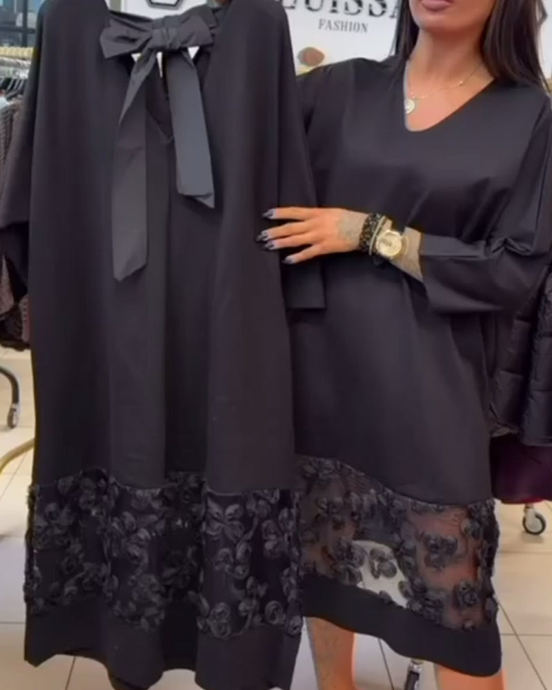 Stilfull Klänning Med Rosett På Ryggen Och V-Ringning