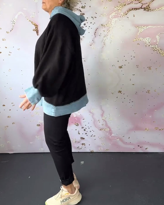 Avslappnad luvtröja på lyktaärm i kontrastfärg