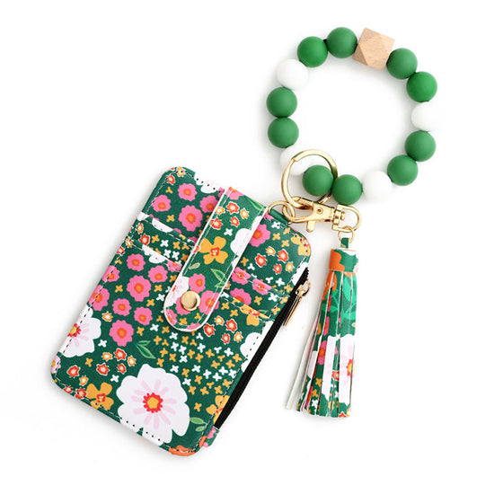 Liten plånbok i blommigt läder med nyckelring och armband