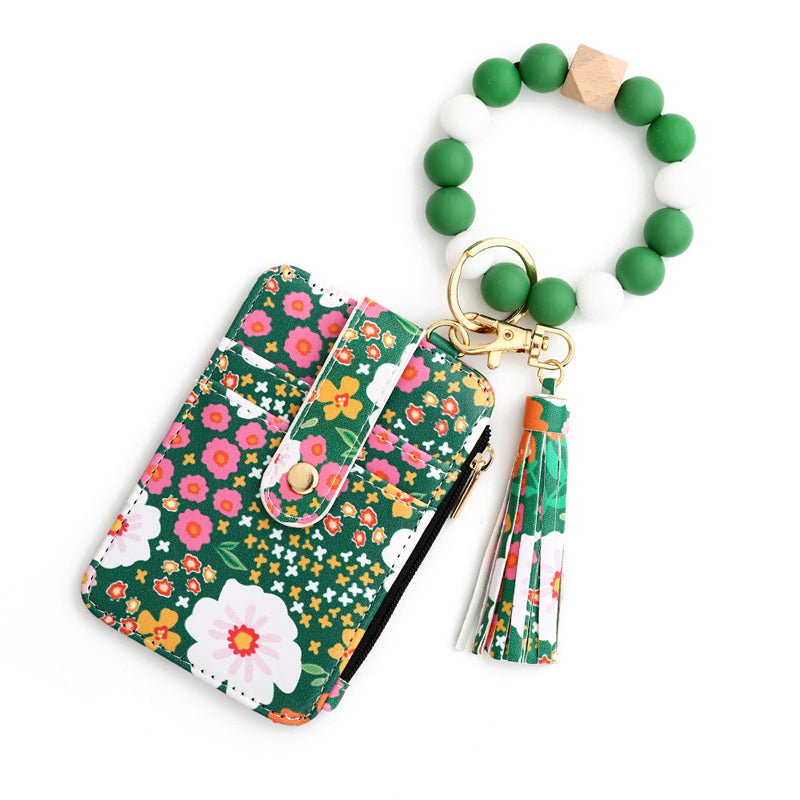 Liten plånbok i blommigt läder med nyckelring och armband