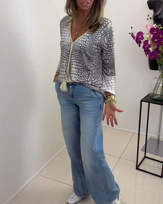 Blus med blommönster och snodd