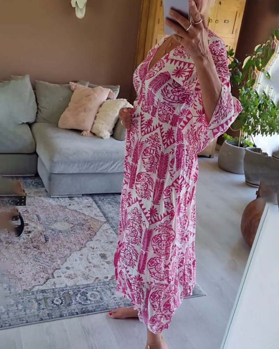 Elegant tryckt klänning med V-ringad veck och bell-sleeve