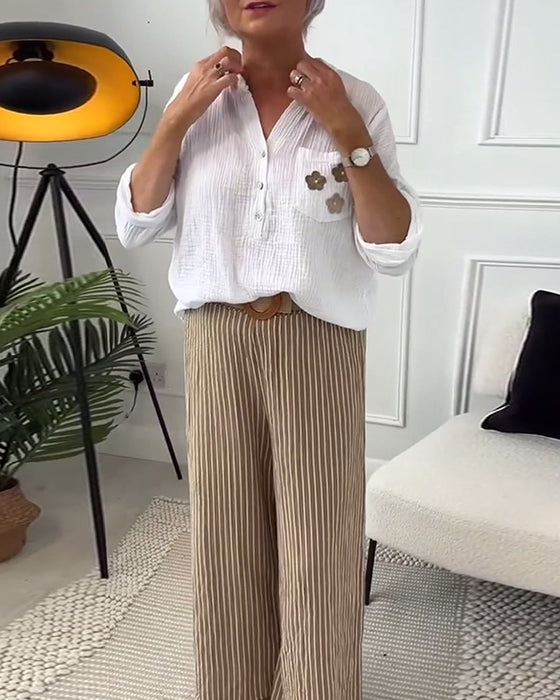 Avslappnad blus med blommigt tryck med ficka och lång ärm