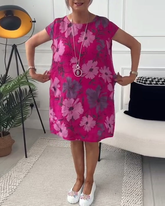 Avslappnad blommig klänning med kortärmade fickor