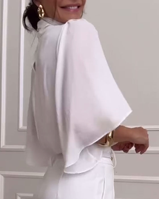 Enfärgad blus med hög krage med fjärilsärm