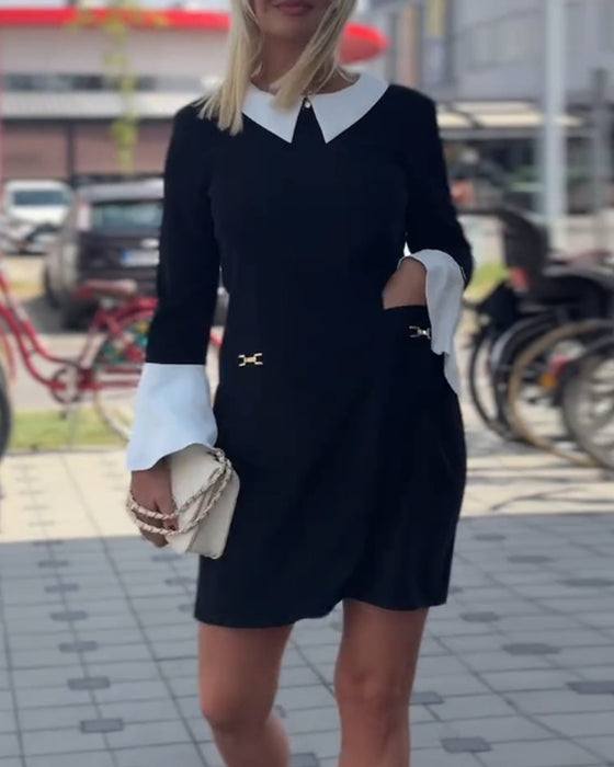 Elegant klänning med klockärm i kontrast