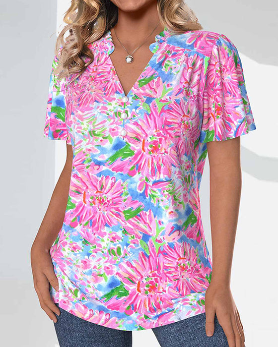 Blus med korta ärmar och blommiga och knappar