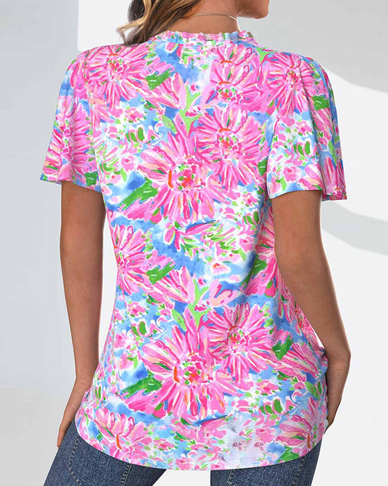 Blus med korta ärmar och blommiga och knappar