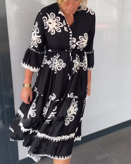 Blommig klänning med 3/4 ärm