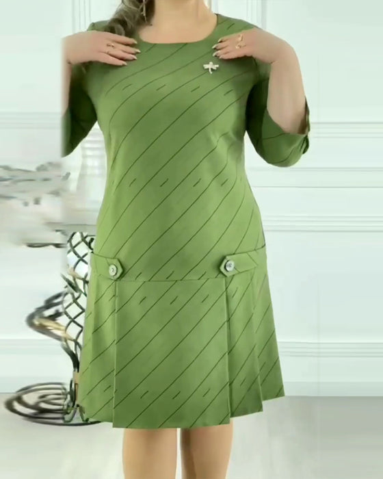 Elegant klänning med rund hals och tryck