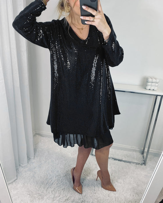 Elegant lös klänning med långa ärmar