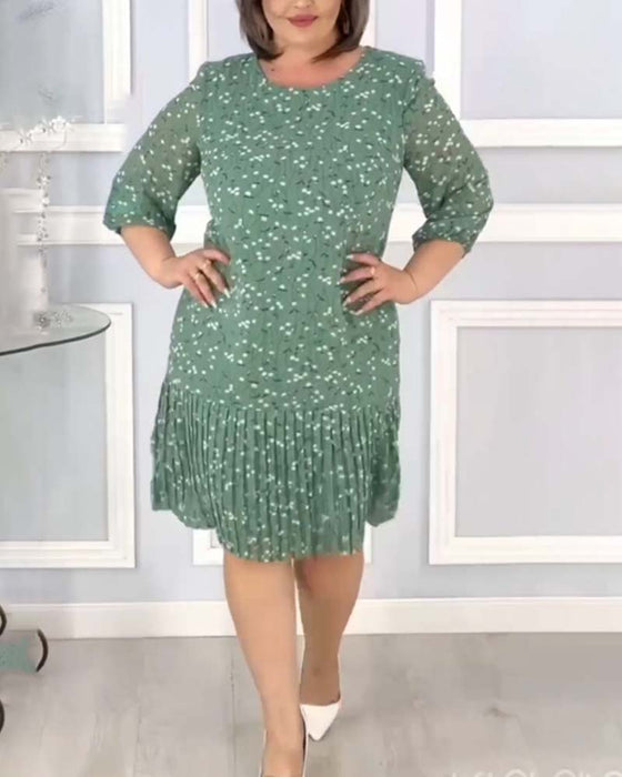 Elegant lapptäckt veckad klänning med tryck